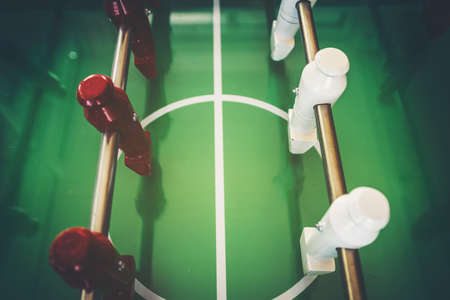 An old wooden football game table with players made of red and white wood.の写真素材
