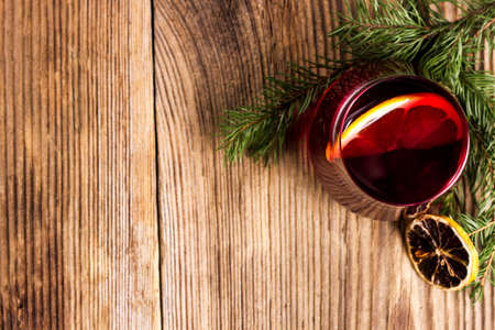 Red tea on a rustic table with branch of pineの写真素材