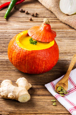 Pumpkin soup served inside of a hollowed pumpkinの写真素材
