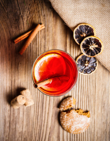 Christmas mulled wine and gingerbread on a rustic wooden table