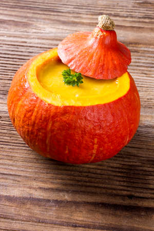 Pumpkin soup served inside of a hollowed pumpkinの写真素材