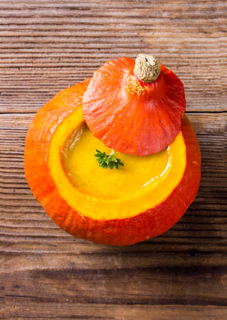 Pumpkin soup served inside of a hollowed pumpkinの写真素材