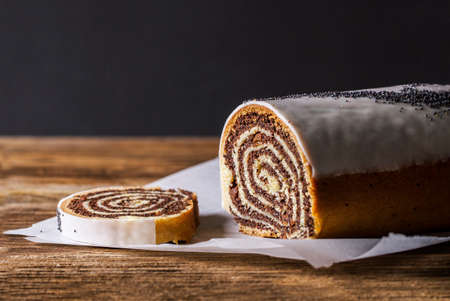 Poppy seed cake roll on a wooden tableの写真素材
