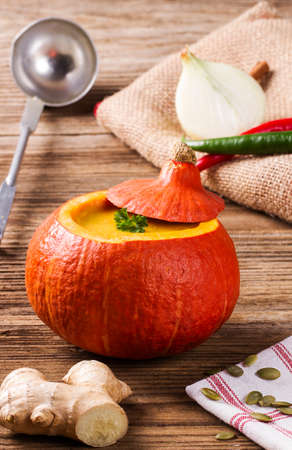 Pumpkin soup served inside of a hollowed pumpkinの写真素材