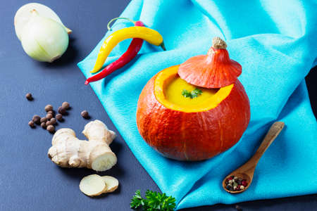 Pumpkin soup served inside of a hollowed pumpkinの写真素材