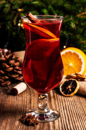 Mulled wine with cinnamon with cone and dried oranges in the backgroundの写真素材