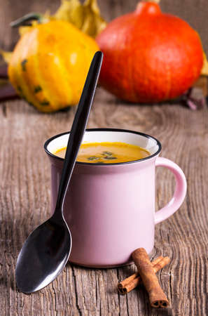 Pumpkin soup with seeds and cinnamon in a enamel mugの写真素材
