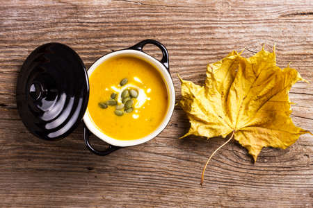 creamy pumpkin soup on a rustic wood en backgroundの写真素材