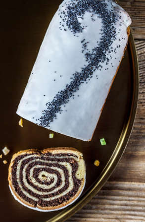 Poppy seeds cake on a golden plateの写真素材