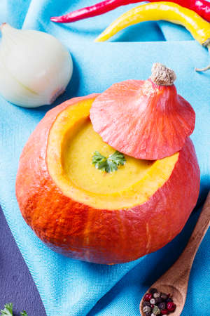 Pumpkin soup served inside of a hollowed pumpkinの写真素材