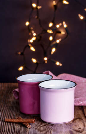 Enamel mugs on a wooden tableの写真素材