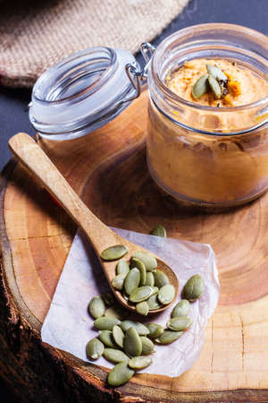Pumpkin puree in a jar with pumpkin seedsの写真素材