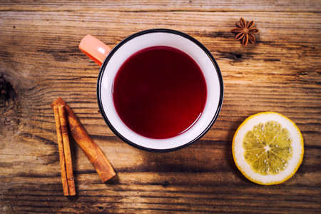 Simple tea mug, cinnamon, lemon and anise on a rustic wooden tableの写真素材