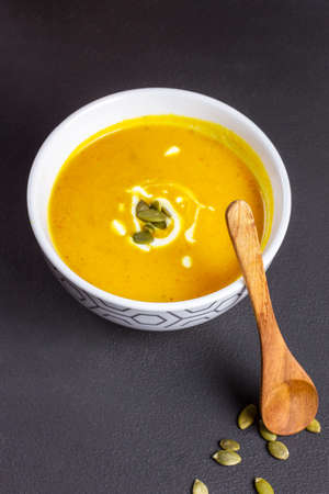 Creamy pumpkin soup in a ceramic bowlの写真素材