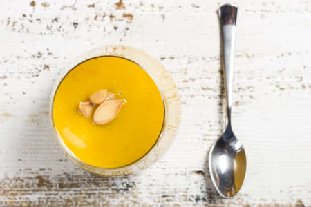 pumpkin soup in a glass on a wooden rustic table, view from topの写真素材