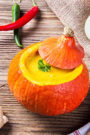 Pumpkin soup served inside of a hollowed pumpkinの写真素材