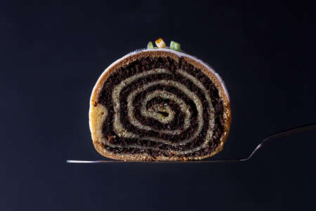 Poppy seed cake roll on a dark backgroundの写真素材