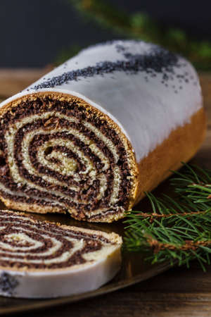 Christmas poppy seeds cake and branch of pineの写真素材