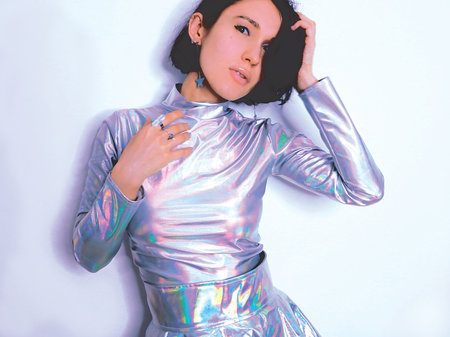 beautiful girl in trendy holographic space suit. fashion art