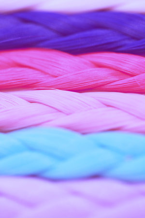 Pigtails from multicolored threads. Macro image. Abstract blurred backgroundの写真素材