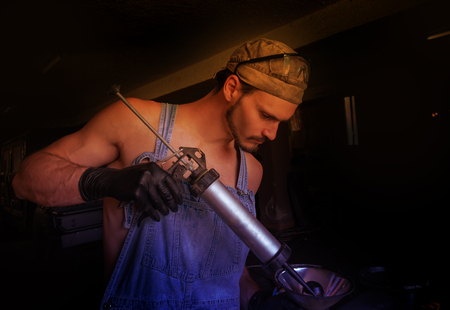 The mechanic works to prepare the parts for the machineの写真素材