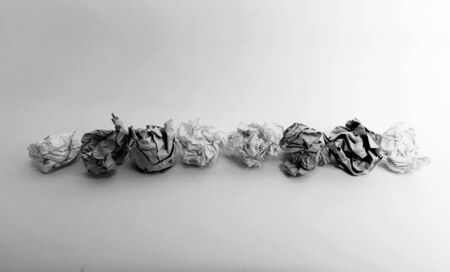 Paper balls on a line in greyscaleの写真素材