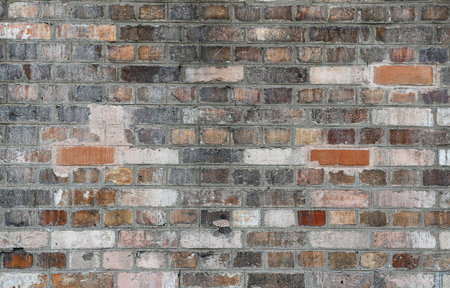 Background of old vintage dirty brick wall with peeling plaster