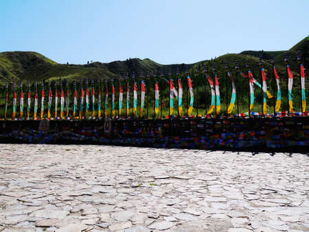 The Tibetan Buddhism in the deep mountains, "Five Dangzhao", is called the Little Potala Palace, there are ancient buildings, and the sacred hall, the scenery of the mountain road is very beautiful, and the prayer flag tower for people. Bright and beautifulの写真素材