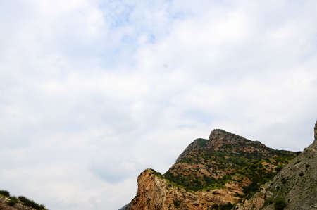 Fun in the mountains, cute goats, beautiful mountains, blue sky, and creeksの写真素材