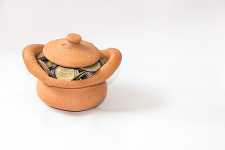 Clay casket full of coins for economy conceptの写真素材