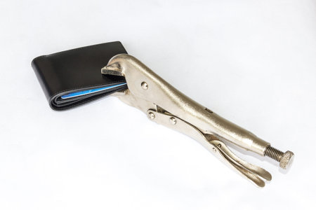Locking Pliers hold a black wallet money for saving money concept