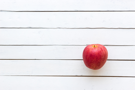 A red apple on wooden white background, Minimalist image styleの写真素材
