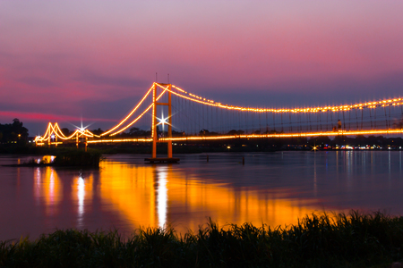 Beautiful landscape of hanging bridge across the Ping river at Evening ,Tak Province,Thailandの写真素材
