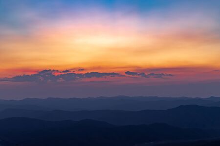 A beautiful colorful of sky and sunrise on the mountainの写真素材
