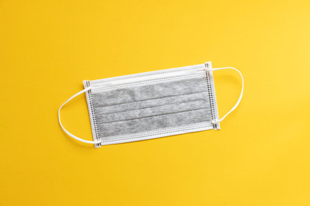 Medical Disposable Face Mask on yellow background,  Protection and Prevention for COVID-19  Novel...