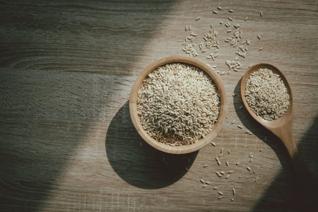 Brown rice on wooden texture background with vintage style, healthy food and carbohydrate nutritionの写真素材