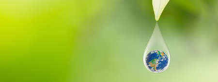 Earth in water drop under green leaf, International Earth Day and World Environment Day Conceptの写真素材