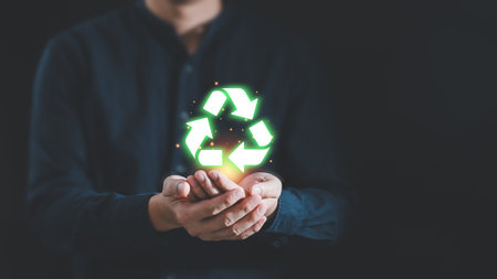 Man hand holding reduce reuse recycle symbol, Ecological and save the earth concept an ecological metaphor for ecological waste management and a sustainable development, Eco recycle technology conceptの写真素材