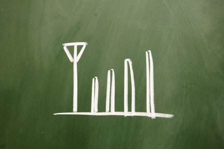 Mobile phone signal drawn with chalk on blackboard