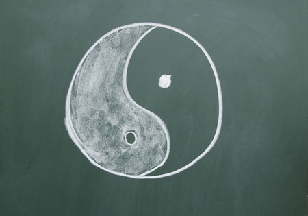 Tai Chi symbol drawn with chalk on blackboardの写真素材