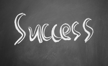 success title written with chalk on blackboardの写真素材