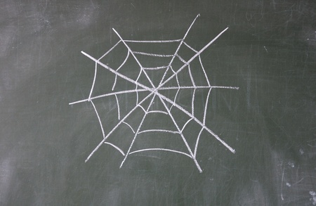 cobweb drawn with chalk on blackboardの写真素材