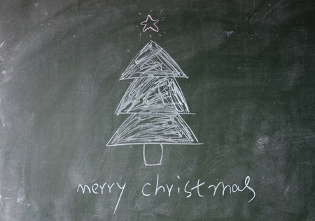 merry christmas title written with chalk on blackboardの写真素材
