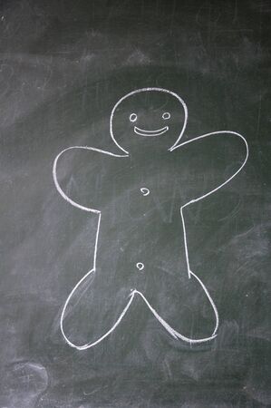 biscuit man drawn with chalk on blackboardの写真素材