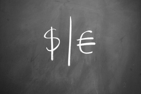 dollar and euro symbol drawn with chalk on blackboardの写真素材