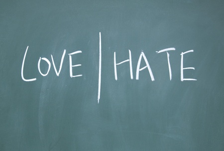 love and hate symbol drawn with chalk on blackboardの写真素材