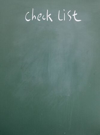 check list title written with chalk on blackboardの写真素材