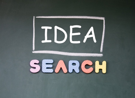 idea search symbol drawn with chalk on blackboardの写真素材