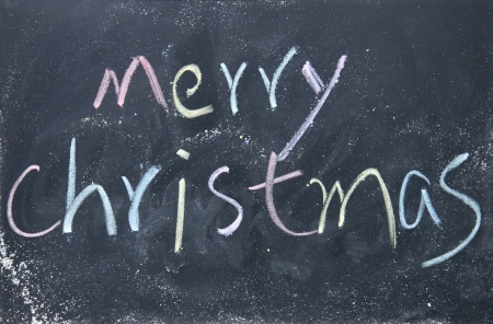 merry christmas title written with chalk on blackboardの写真素材