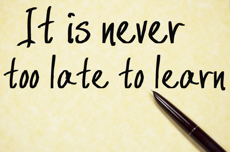 it is never too late to learn text write on paperの写真素材